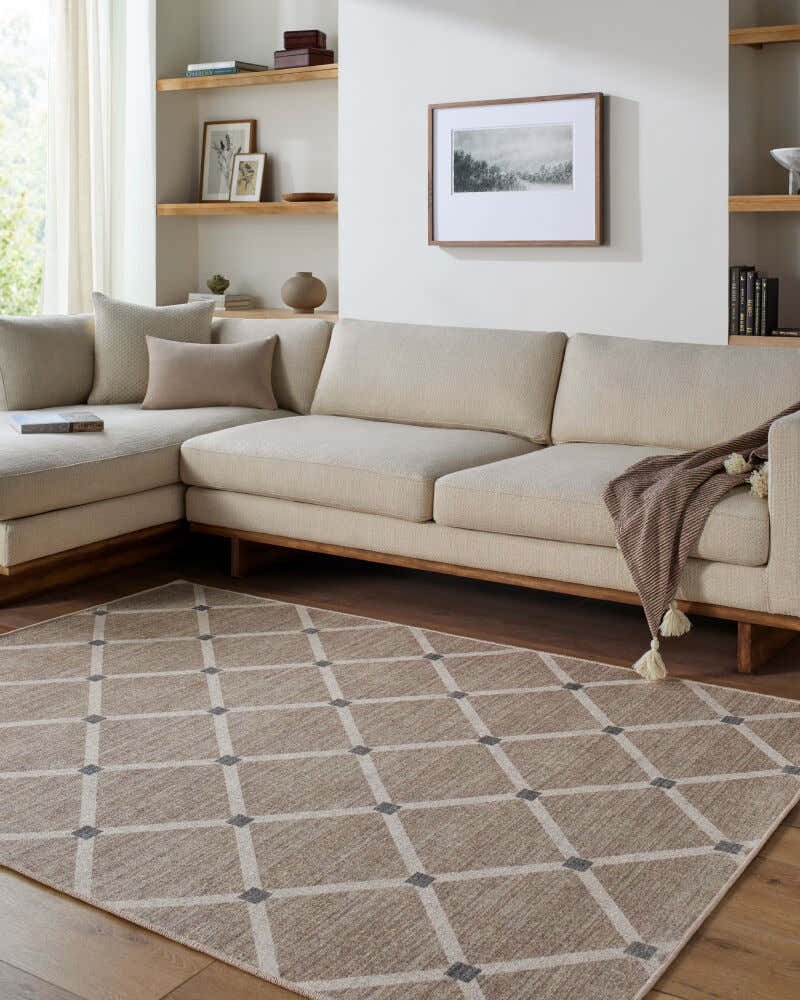 Living room scene with beige sectional and Alpana Washable Wool Area Rug in beige, ivory, and slate gray with a geometric pattern. Roomscene-Rectangle