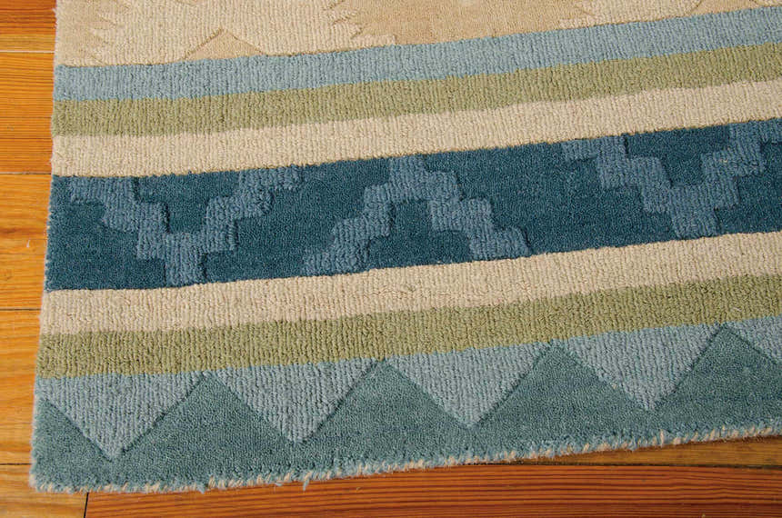 Close up of the handmade Nourison India House Blue Green Persian rug showing wool texture and geometric pattern.