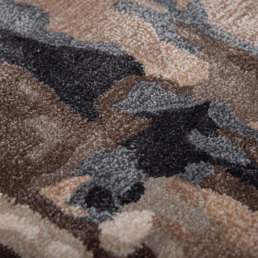 Close up of the hand-tufted Rizzy KIN533 area rug. Beige, charcoal, brown, red, and ivory create a contemporary pattern. Texture