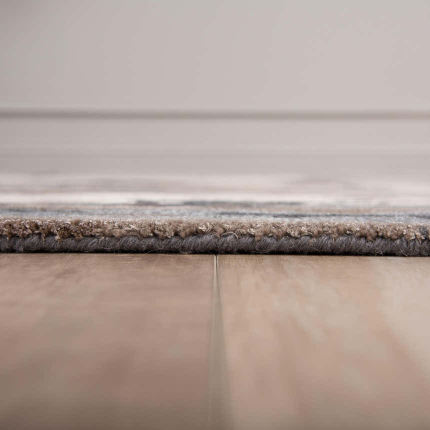 Close-up of Rizzy KIN533 area rug showing beige, charcoal, and brown tones. Hand-tufted wool and tencel texture. Pile