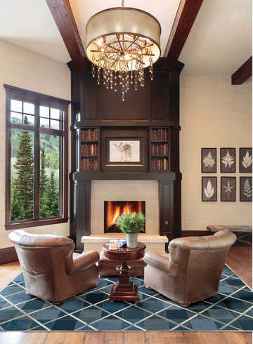 Living room with leather chairs and Barclay Butera Cooper Indigo rug, fireplace, and mountain view.