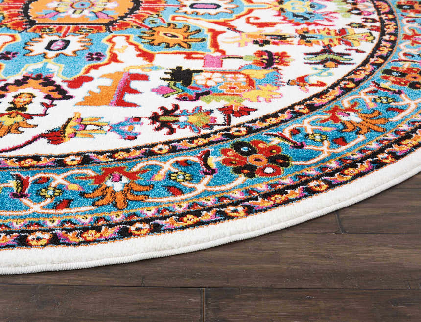 Close-up of Nourison Oakdale Ivory Vintage rug showing colorful floral pattern in chestnut, red, orange, and blue on a round rug.