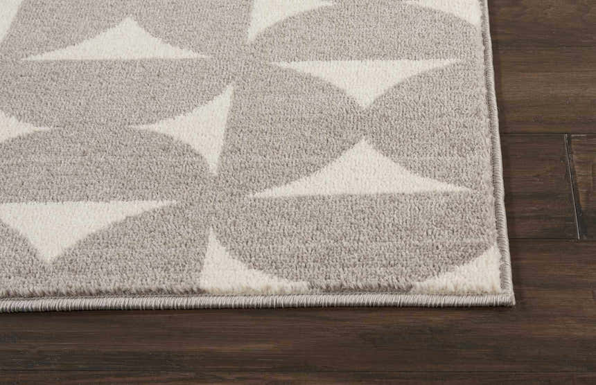 Close up of the Nourison Harper Grey Colorful rug, featuring a geometric circle and triangle pattern.