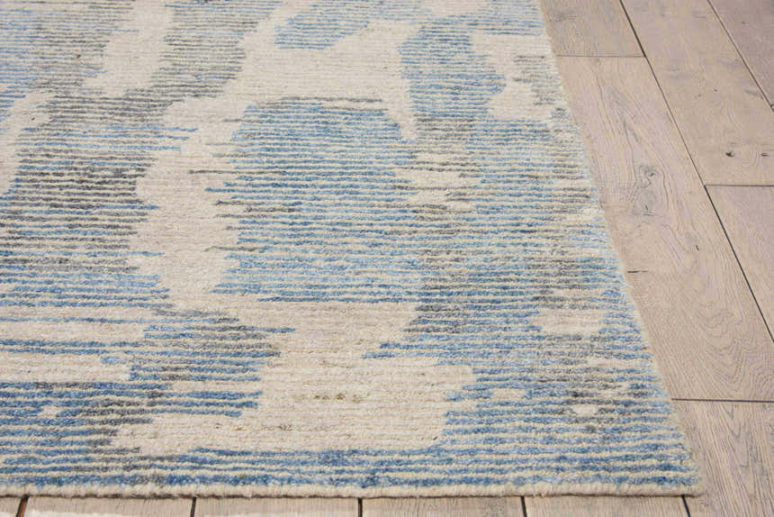 Close-up of the light blue Nourison Ellora rug. Handmade rayon rug with a modern abstract pattern and textured feel.