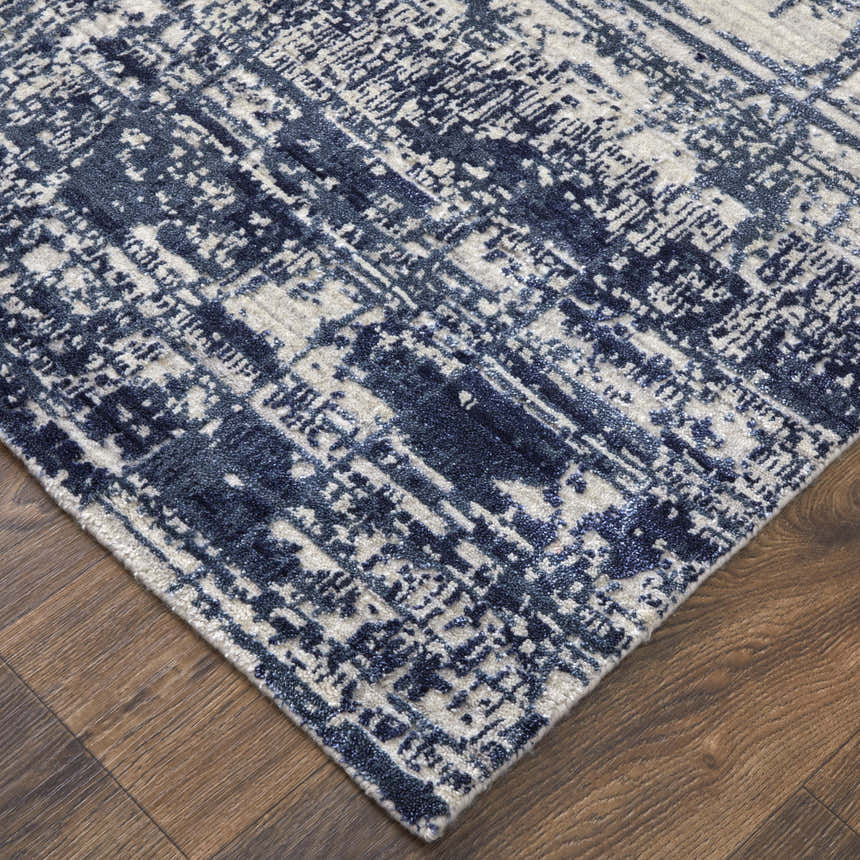 Close up of the Feizy Eastfield rug. Modern abstract design in blue and ivory on a hand woven wool and viscose rug. Corner