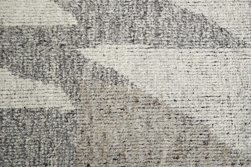 Close-up of the Feizy Alford Area Rug. Ivory, gray, and taupe wool with a geometric pattern and hand-knotted texture. Texture
