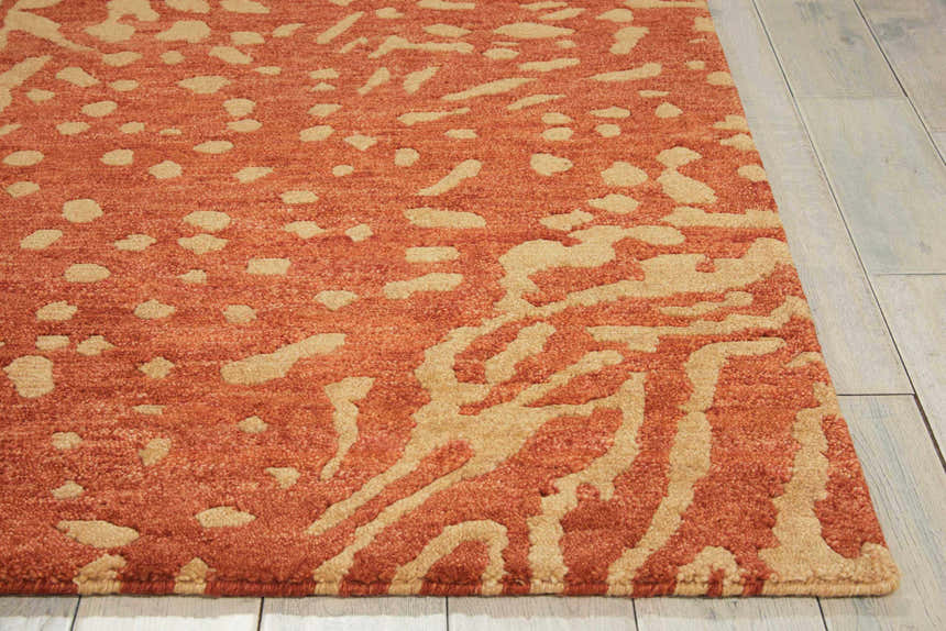Close-up of the Nourison Tahoe Rust/Beige rug, showcasing its abstract pattern and wool texture. Modern design.