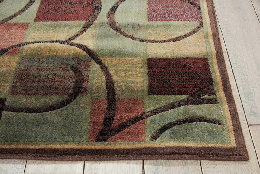 Close-up of Nourison Expressions Brown rug. Geometric squares and circles in brown, green, and red. Mid-century modern style.
