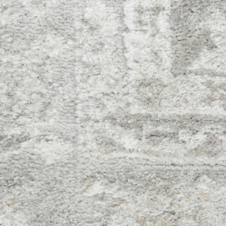 Close up of the high pile, grey vintage pattern on the Nourison Dekor area rug.