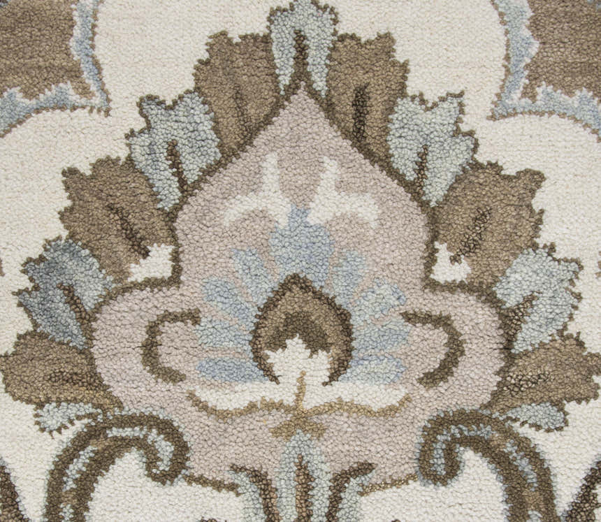 Close up of Rizzy LO9987 area rug showing hand tufted wool texture and farmhouse style floral pattern in brown, ivory, and gray. Texture