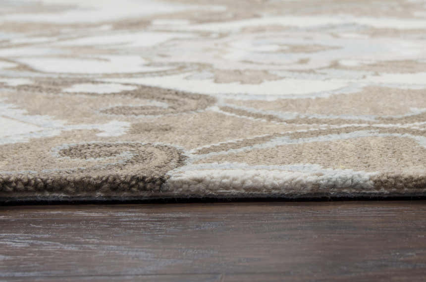 Close-up of the hand-tufted Rizzy LO9987 area rug. Ivory, light brown, and gray floral pattern. 100% wool texture. Pile
