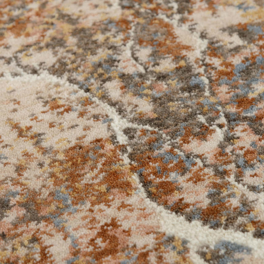 Close-up of Rizzy LOG734 area rug showing abstract pattern, beige, rust, and dark red colors, and soft texture. Texture