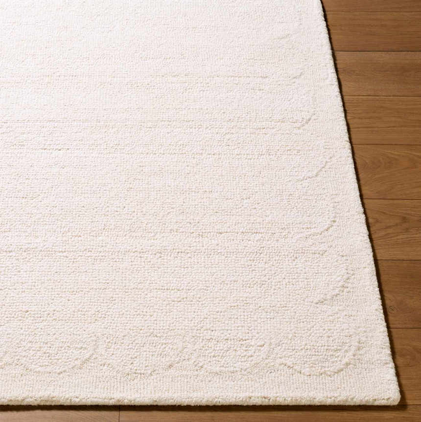 Close up of the hand tufted Kazuto Area Rug. Cream wool rug with subtle pattern detail. Front