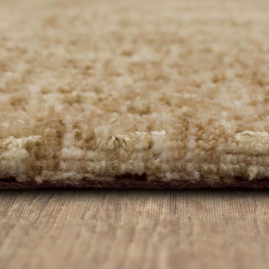 Close-up of the plush texture of the Karastan Lost City Khaki Area Rug; tan farmhouse style rug. Pile