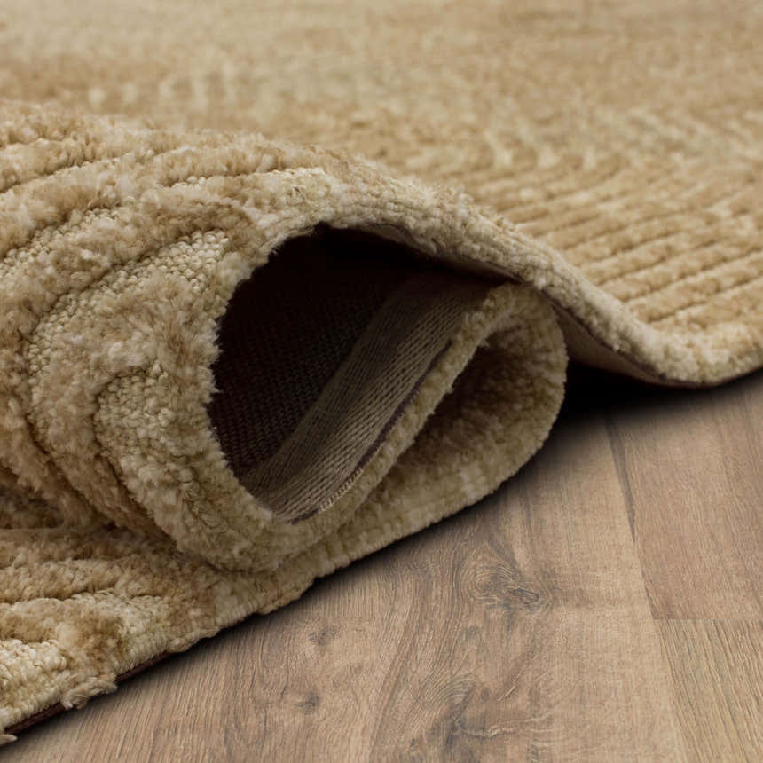 Close-up of the tan Karastan Lost City Khaki Area Rug showing its plush texture and machine-made construction. Fold