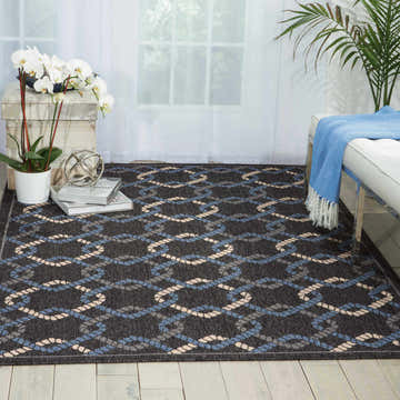 Living room scene with a Nourison Caribbean Charcoal rug featuring a rope design in taupe and blue.
