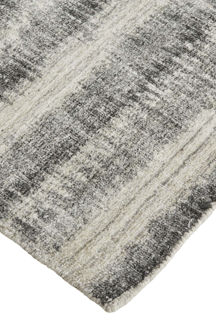 Close-up of Feizy Mackay rug showing gray, ivory, and black stripes with a hand-woven texture. Corner