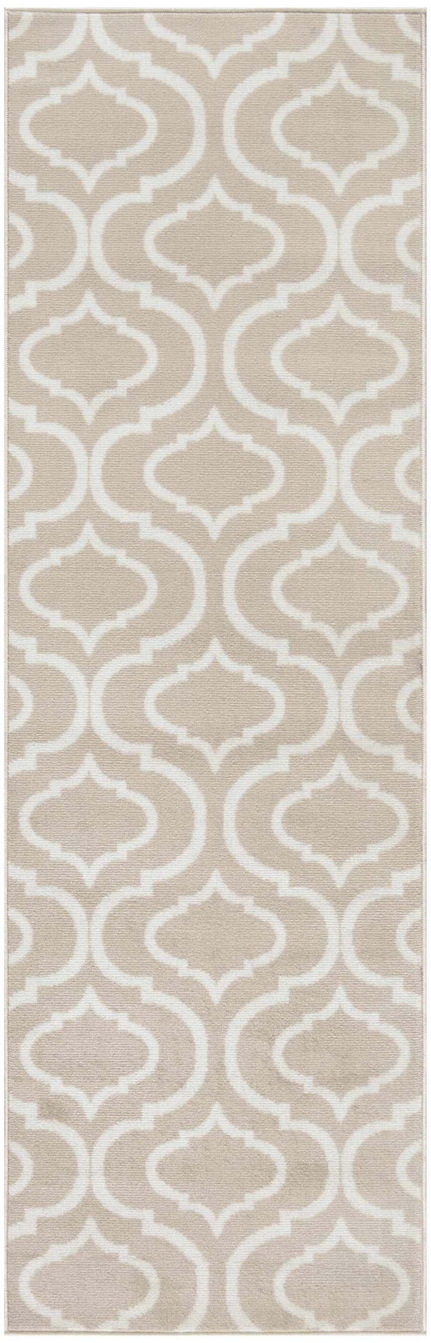 Close-up of the Nourison Jubilant Beige Contemporary Indoor Area Rug with a white quatrefoil pattern.