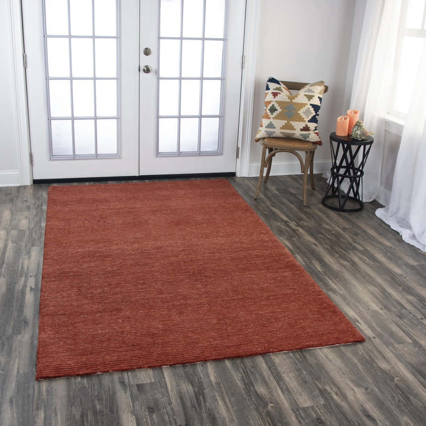 Entryway with dark wood floors and Rizzy MPK101 dark red rug. White french doors and chair with patterned pillow. Roomscene-Rectangle