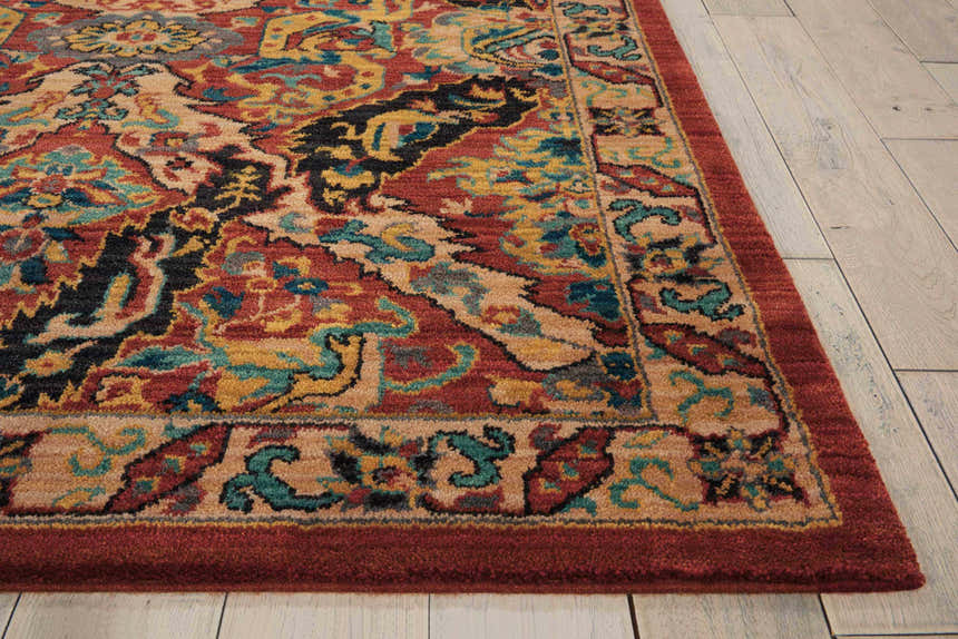 Close up of Nourison 2020 Terracotta rug showing burnt orange, gold, teal, and black traditional floral pattern.