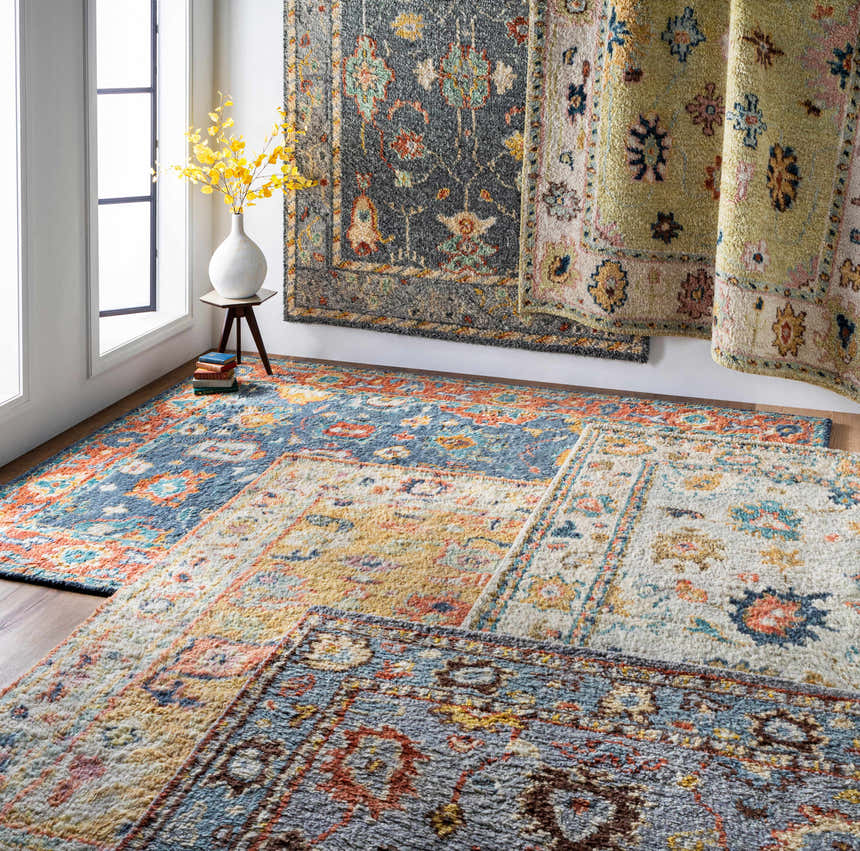 Prosperidad Handmade Wool Rugs in a bright room scene. Bohemian, traditional rugs in brick red, cream, and charcoal colors. Styleshot