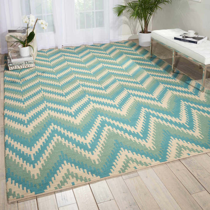 Living room scene with a Barclay Butera Prism Pacific rug in Pacific color, featuring a zigzag pattern.