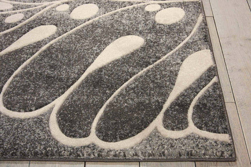Close-up of the Nourison Maxell Grey rug showing its abstract, mid-century modern design and textured polyester material.