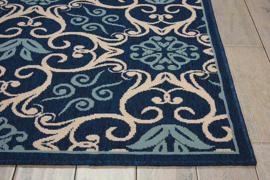Close-up of Nourison Caribbean Navy Contemporary Area Rug showing a floral and scroll pattern in navy, cream, and light blue.