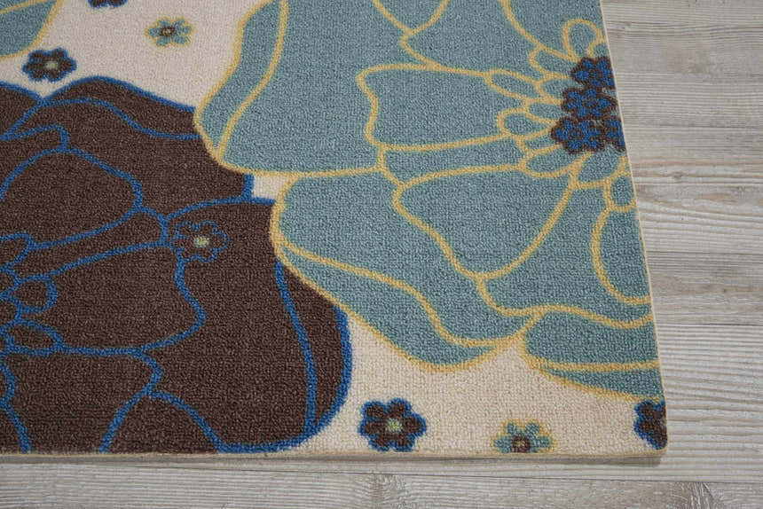Close-up of the Nourison Home & Garden Light Blue rug, featuring a floral design in light blue, brown, and cream.