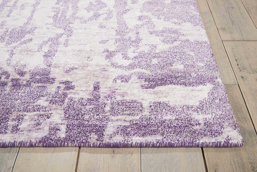 Close up of the Nourison Silk Shadows Amethyst rug showing its vintage purple pattern and soft texture.
