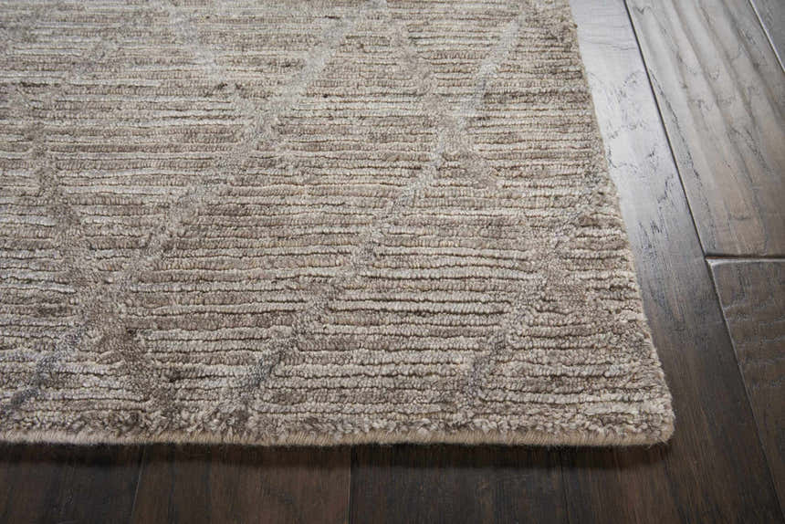 Close-up of the handmade Nourison OCEAN Ash area rug; shows ash color, subtle pattern, and textured pile.