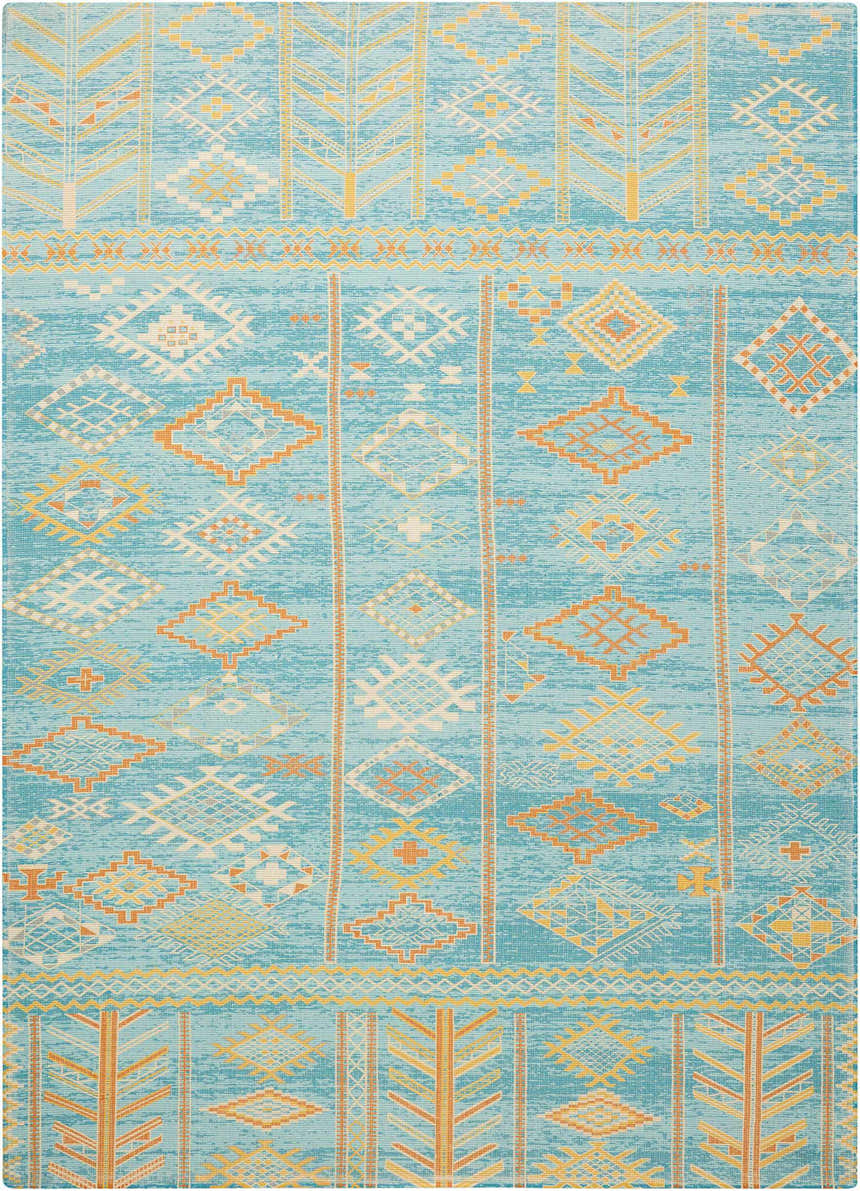 Close-up of Nourison Madera Sky Blue rug. Tribal design with orange, yellow, and white geometric patterns on a sky blue background.