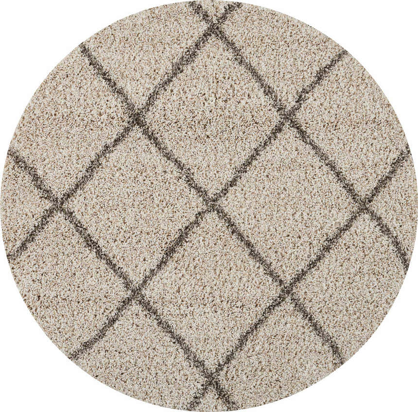 Close-up of a round, cream shag Nourison Brisbane rug with a subtle diamond pattern. Soft texture.