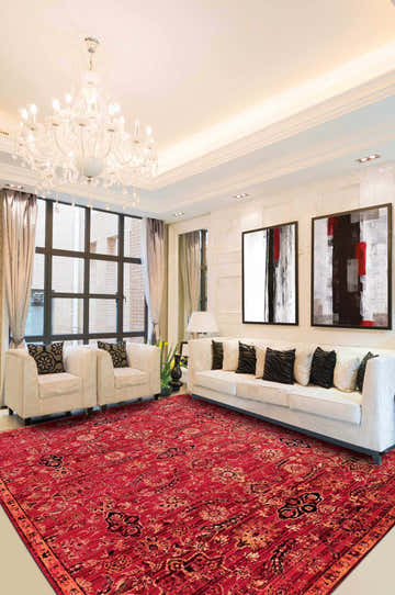 Elegant living room with a Nourison Timeless Red Persian rug, white sofa, and modern art.