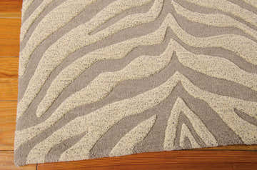Close-up of the ash Michael Amini Zambiana rug. Eclectic zebra-like pattern in wool with textured pile.