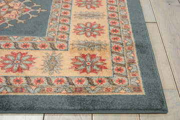 Close-up of Nourison Maymana Midnight Persian rug showing floral pattern, beige and red accents, and soft blue border.