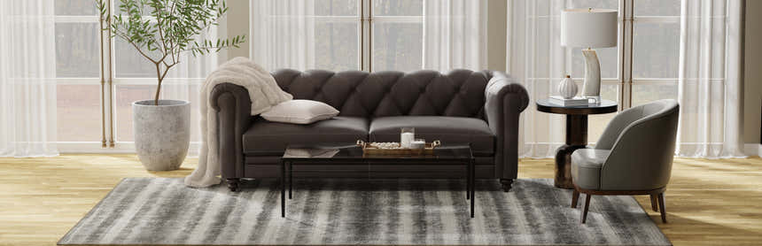 Living room scene with a Feizy Mackay gray striped rug, brown sofa, and neutral decor. Roomscene-Rectangle