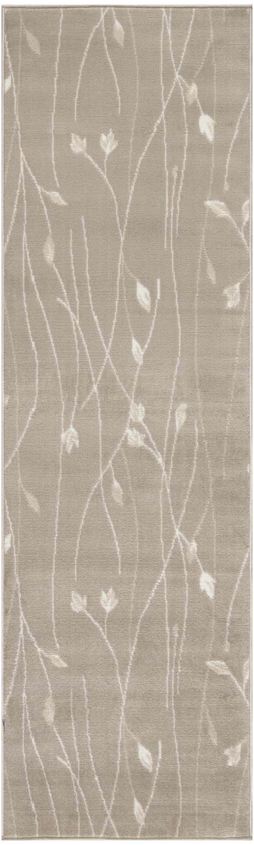 Close-up of Nourison Grafix Beige rug showing a modern floral vine pattern and soft texture.