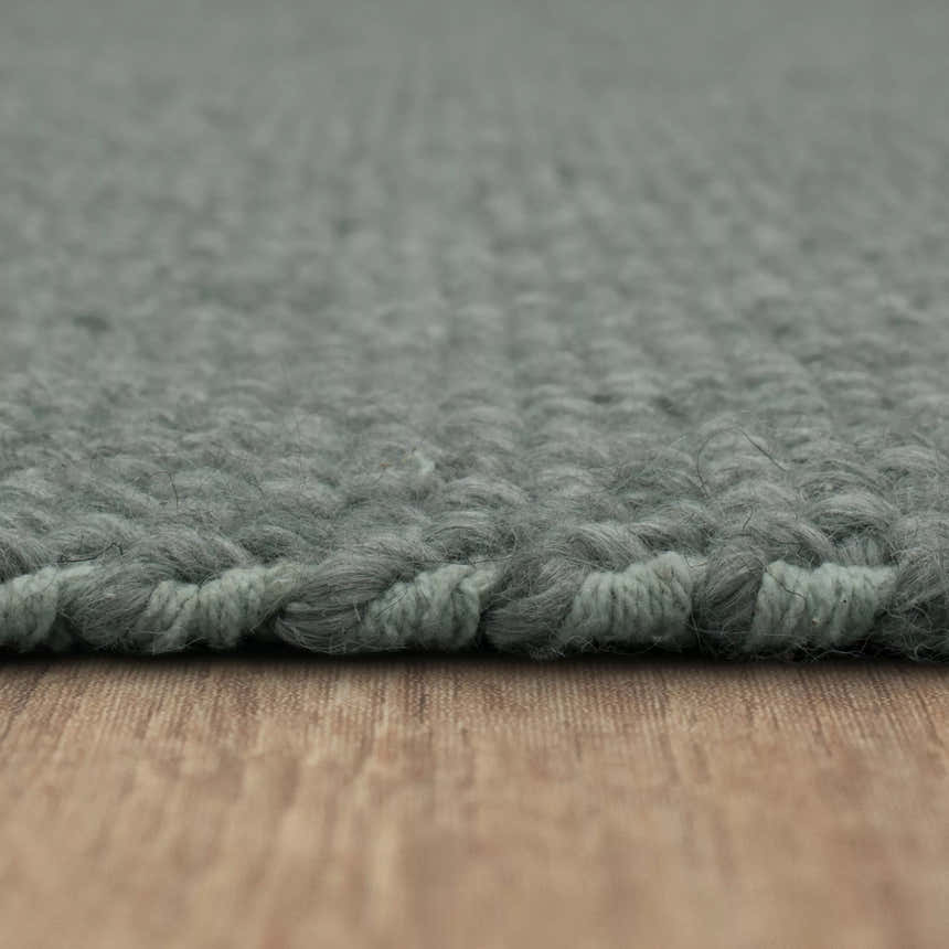 Close-up of the hand-loomed Karastan Paloma Seaglass Area Rug. Shows gray-green color and wool blend texture. Pile