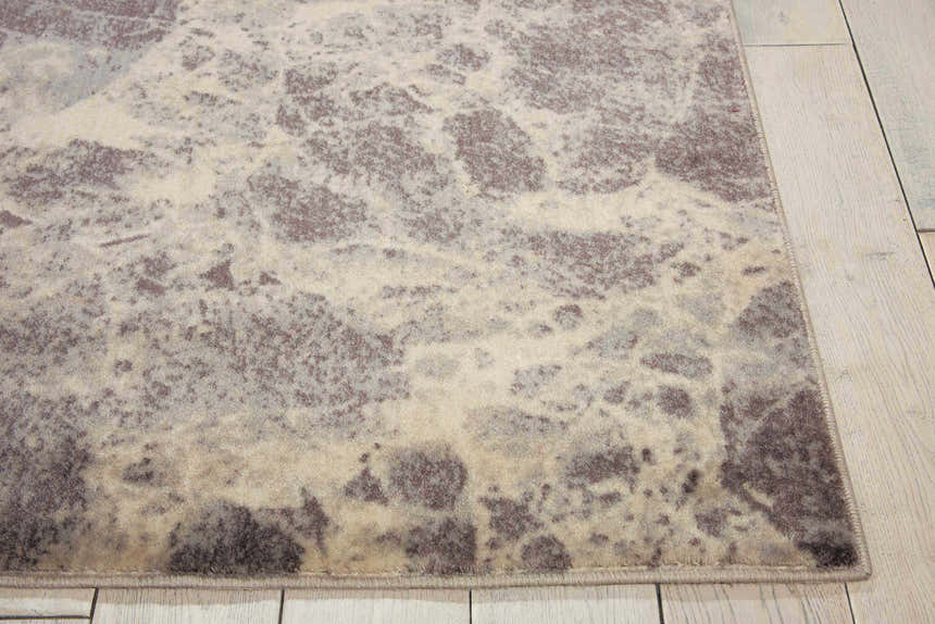 Close-up of Nourison Somerset Grey rug. Modern design with gray, beige, and taupe marbling pattern. Soft texture.