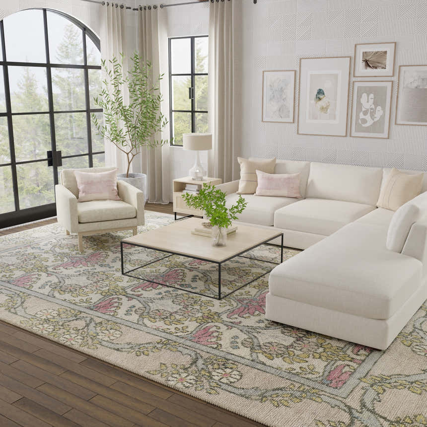 Living room scene with Feizy Beall Ivory/Pink/Green rug, neutral sofa, chair, and light wood accents for a farmhouse vintage feel. Roomscene-Rectangle