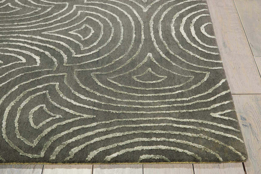 Close-up of the olive Nourison Vita Moss rug featuring a raised, abstract geometric pattern.