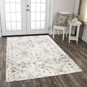 Entryway with Rizzy PLC860 area rug in beige, black, and ivory. Farmhouse style with white door, chair, and side table. Roomscene-Rectangle