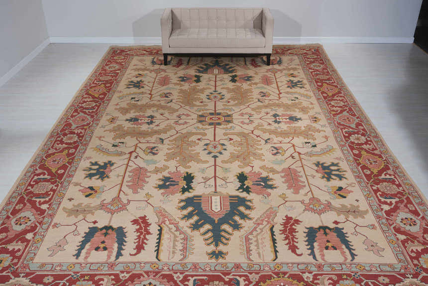 Living room scene with a light gold Nourison Nourmak vintage rug, beige sofa, and white walls.