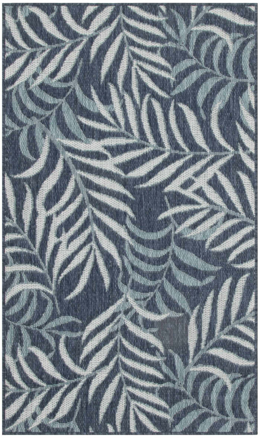 Close-up of the Nourison Garden Oasis Navy Tropical Area Rug, featuring a woven leaf pattern in shades of navy and white.