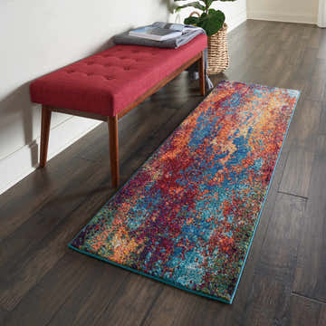 Hallway scene with a Nourison Celestial Atlantic runner rug, red bench, and dark wood floors.