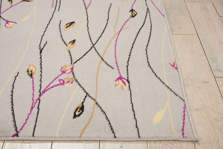Close-up of Nourison Grafix Grey Contemporary Indoor Area Rug with floral design, gray, black, gold, and magenta colors.