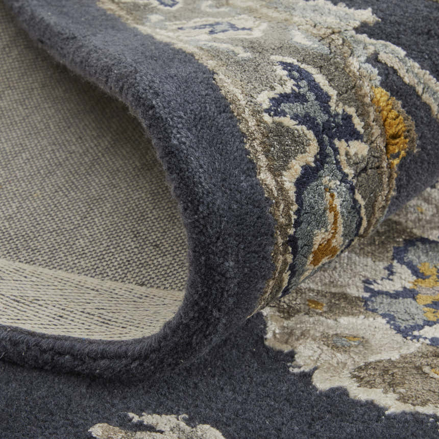 Close-up of the Feizy Prescott rug in blue, silver, and gray, showing the floral pattern and hand-tufted texture. Fold