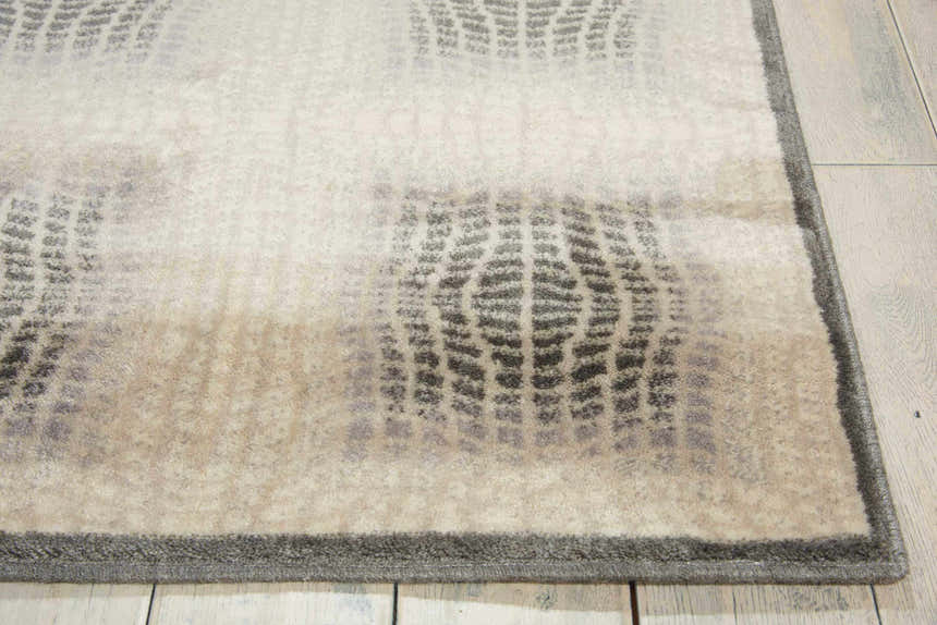 Close-up of the Nourison Utopia Shell rug showing its shell color, geometric pattern, and soft texture.