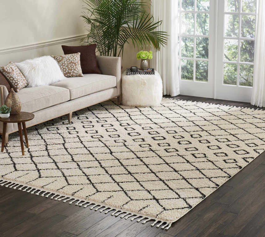 Living room with a cream sofa and Nourison Moroccan Shag Cream Tribal rug with a geometric pattern.